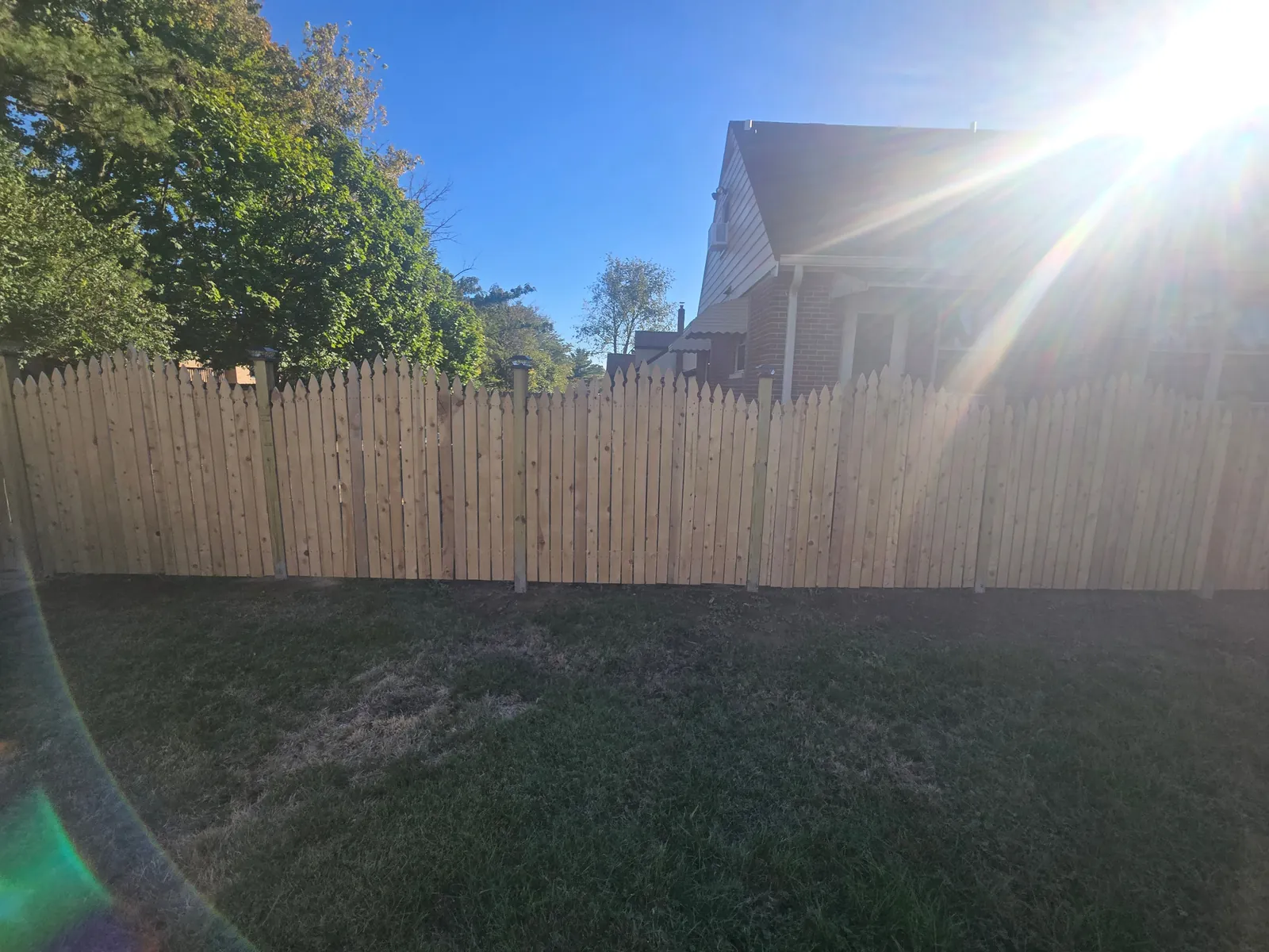 Gail project newly constructed wood privacy fence around the yard