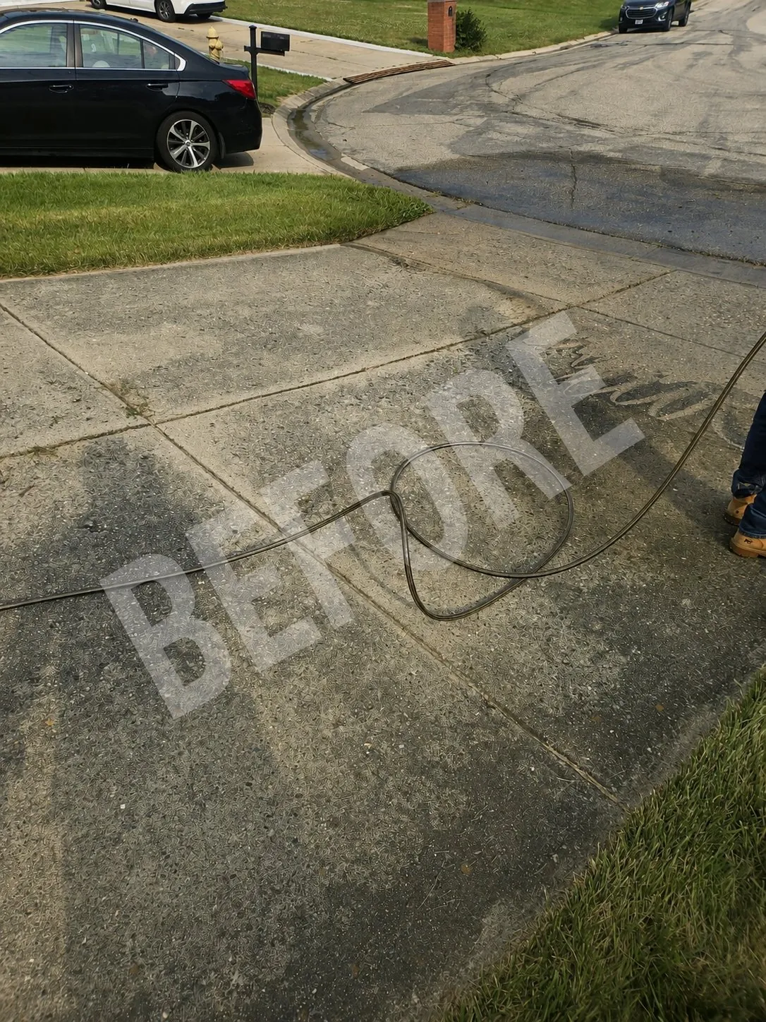 Driveway concrete with dark dirt and weathering before washing