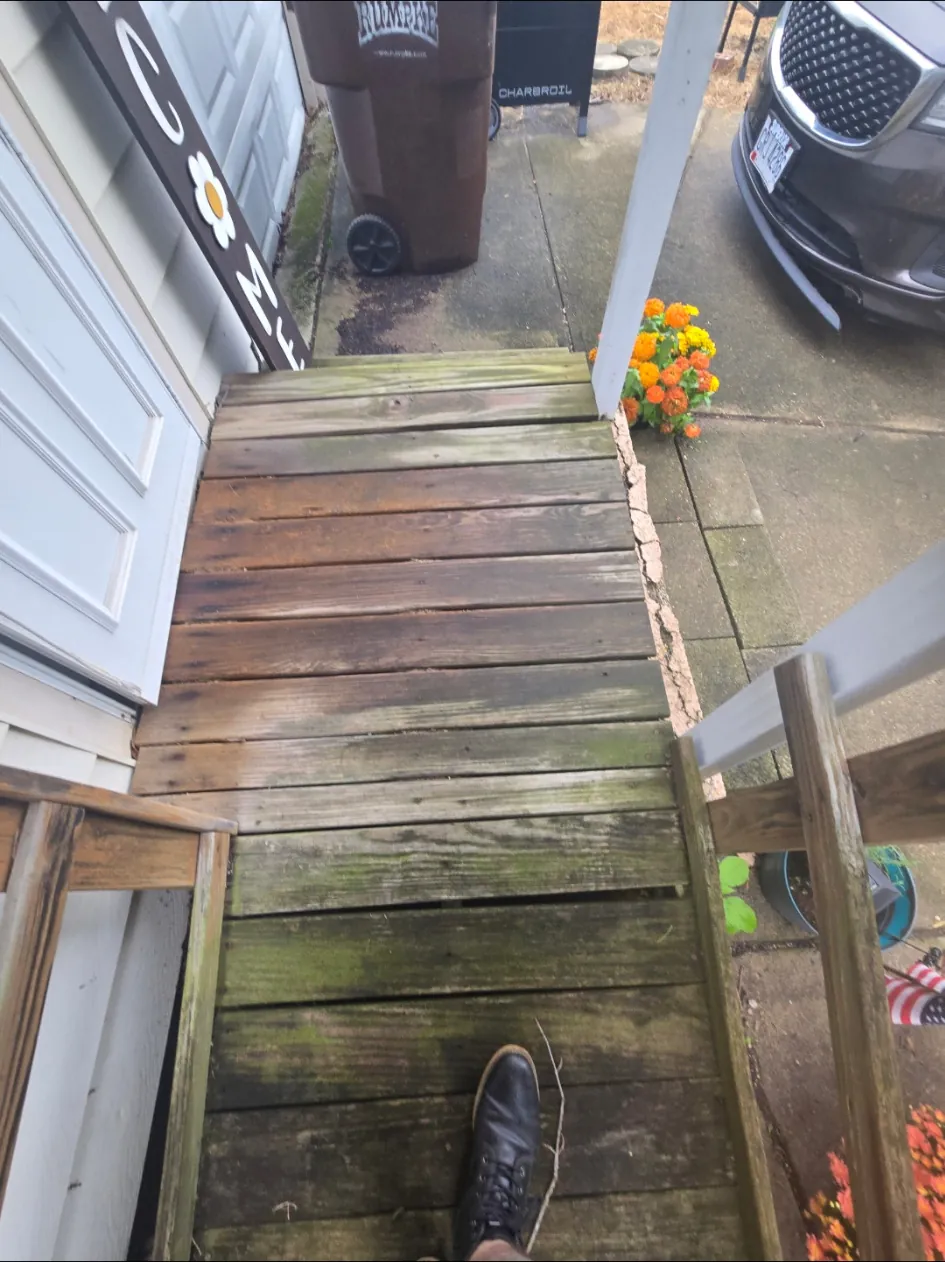 Close view of warped and weathered access ramp boards before replacement