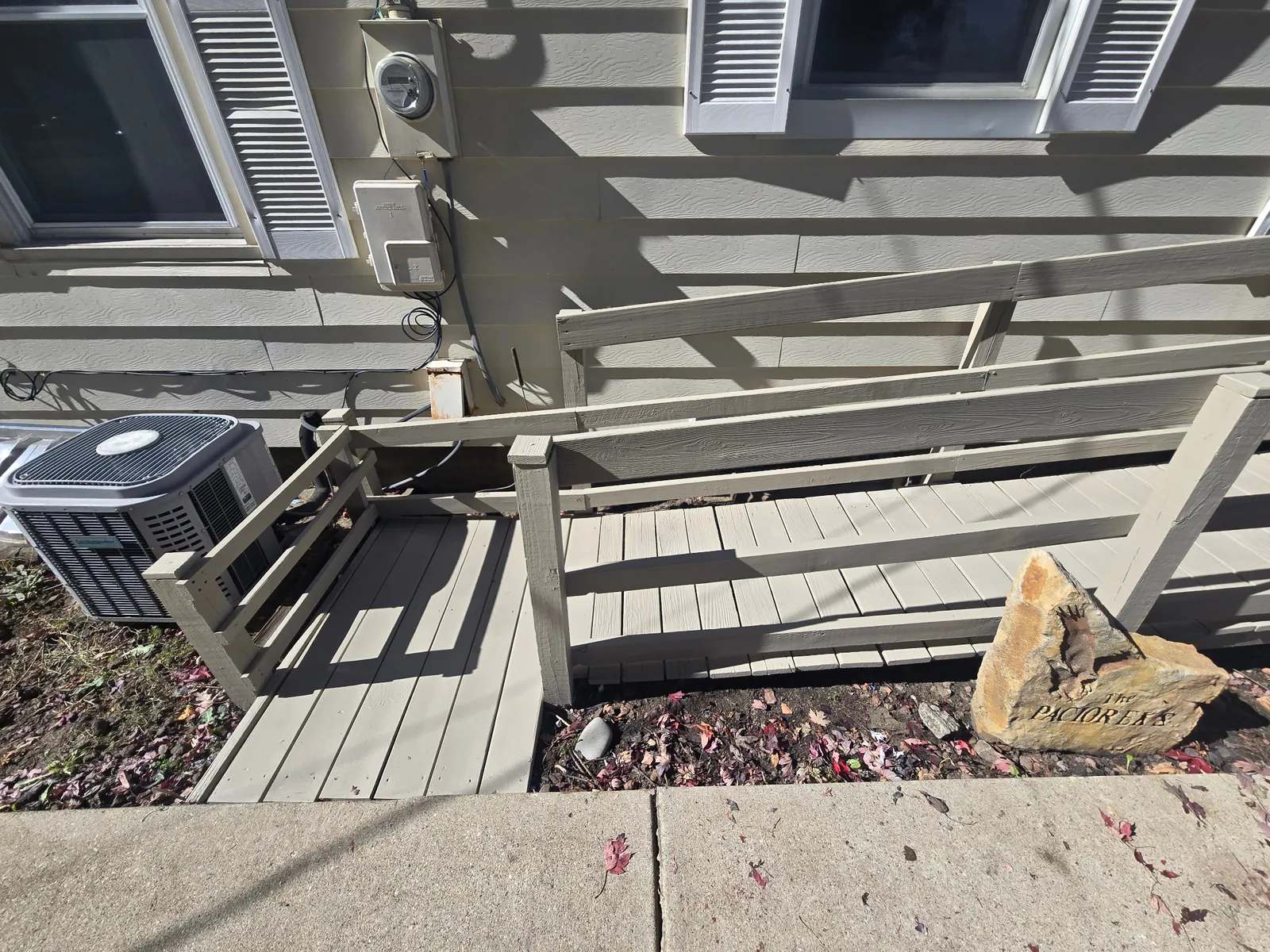 Restored handicap access ramp entry with repaired boards and fresh paint