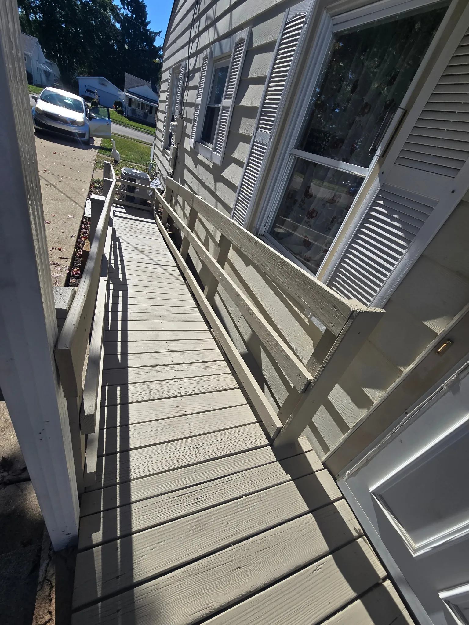 Painted access ramp deck and handrails after restoration viewed from the walkway